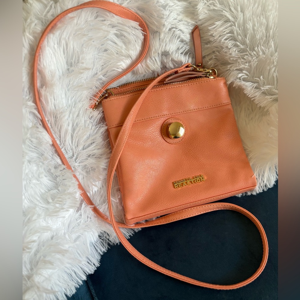 Peach colored Kenneth Cole Reaction long strapped purse.